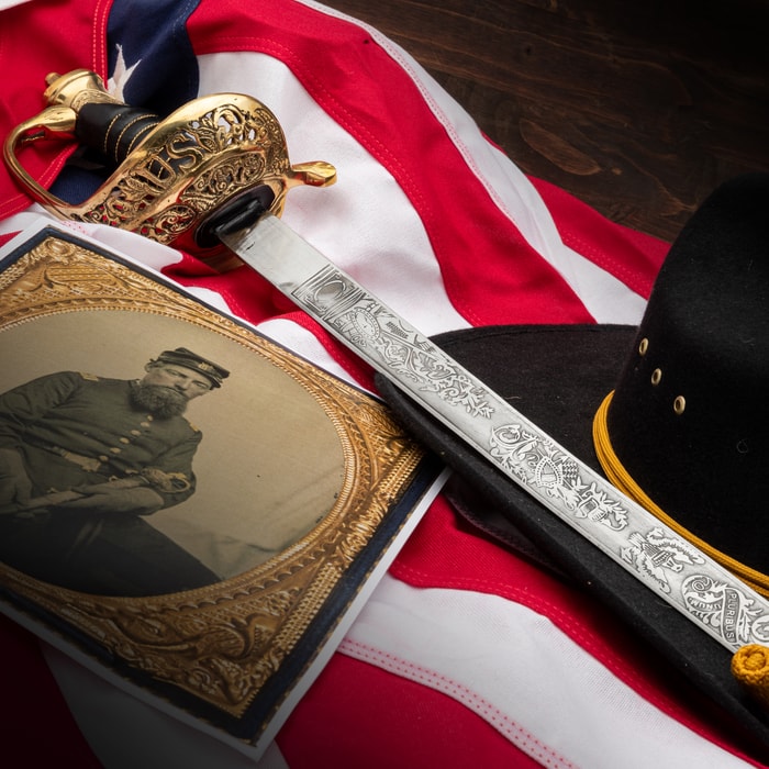 Field officers sword shown from various angles, with a focus on the detailed brass guard, etching on the blade, and metal scabbard with brass fittings. 