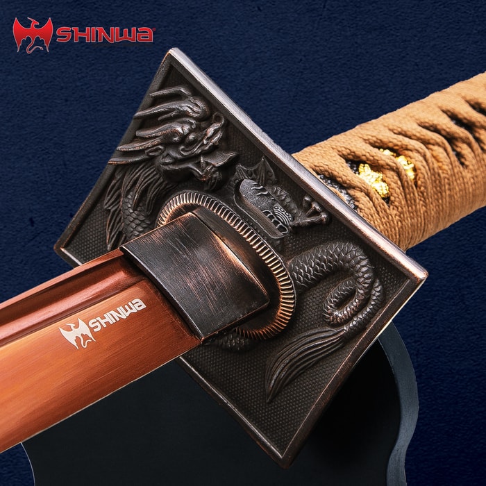 The tsuba of the Shinwa Copper Dragon Katana has an intricate dragon design, leading to the brown cord wrapped handle. 