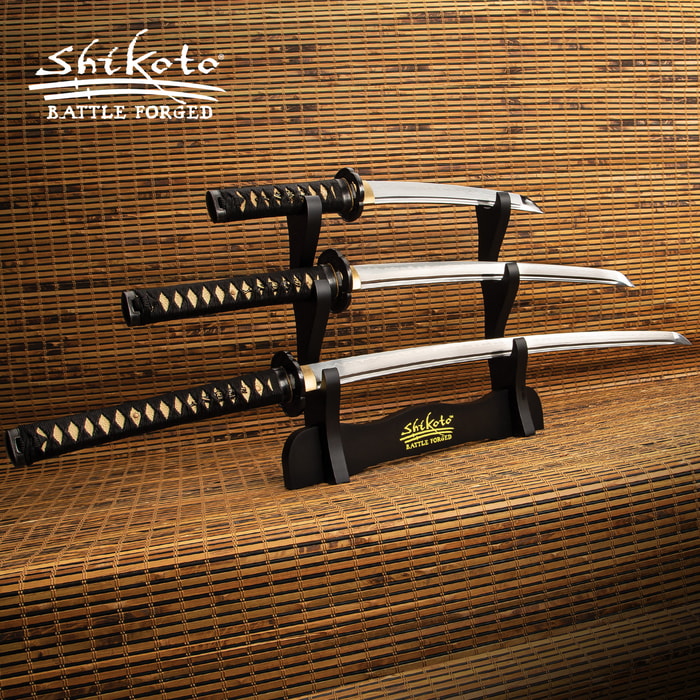 Shikoto three piece katana set with T10 carbon steel blades showcased on a black wooden sword stand
