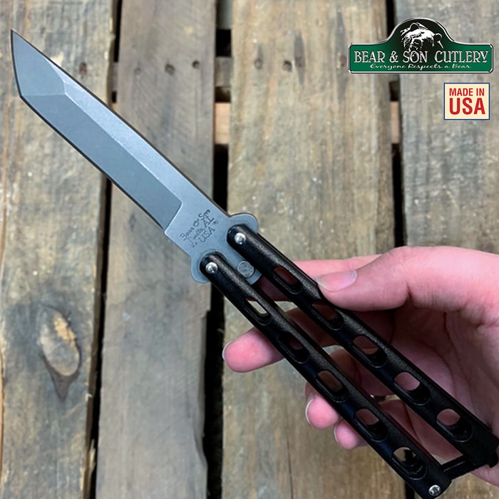 Bear Armor Piercing Black Butterfly Knife has a high carbon stainless steel hollow ground blade and dark epoxy power-coated handles.