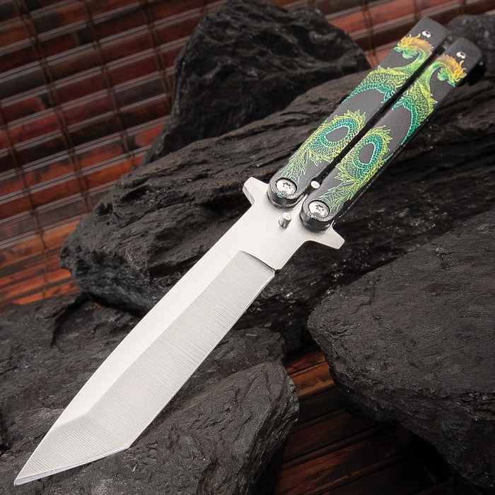 The Twin Dragons Green and Yellow Butterfly Knife has a 4” stainless steel blade with satin finish and black steel handles with dragons.