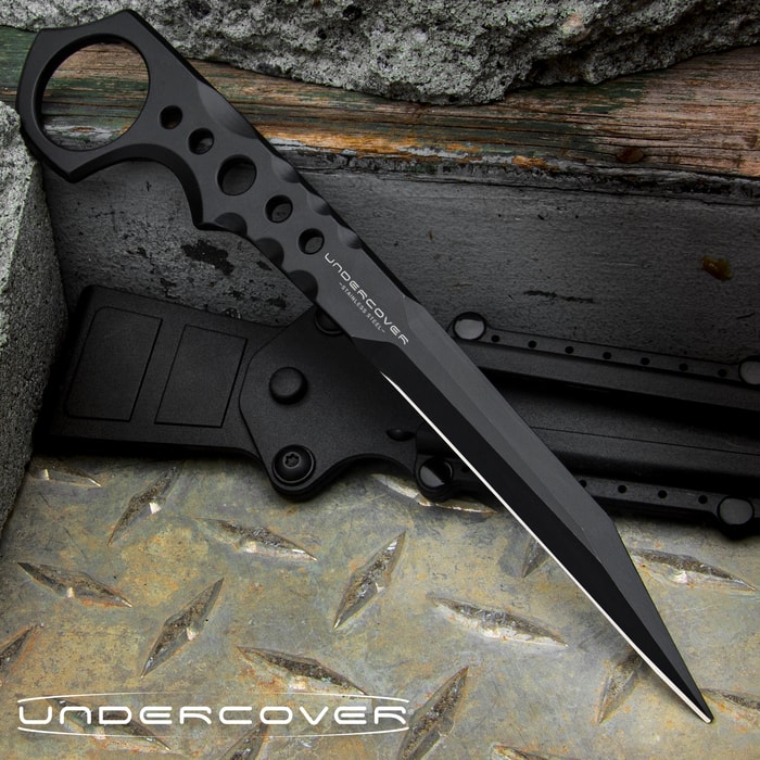 Slim black 7 1/4" stinger knife with an open ring pommel and the text "UNDERCOVER" displayed in the center of the knife and in the bottom left corner. 
