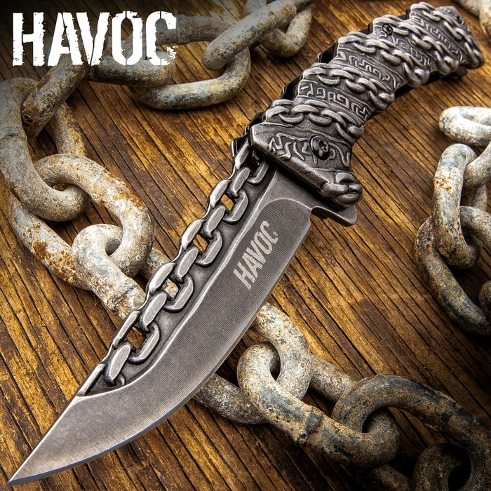 Knife with chain design on wooden surface