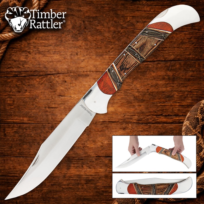 Folding knife with wood and metal handle on wooden background