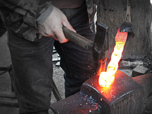 Forged layers of steel being hammered